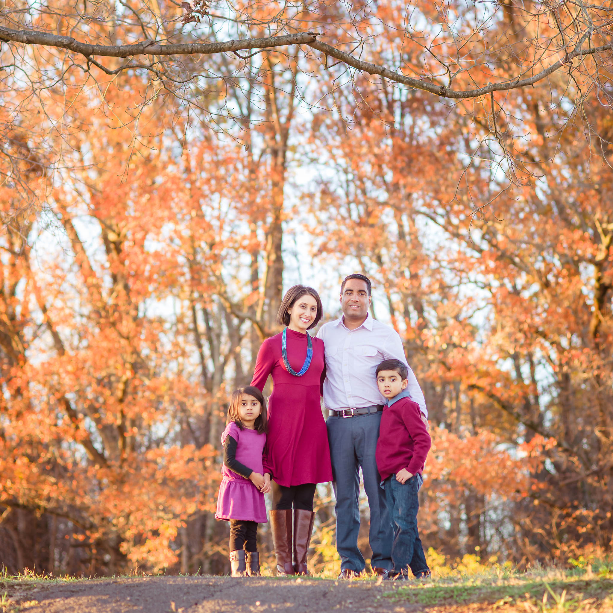 fall family photo with fall foliage at Lenoir City park
