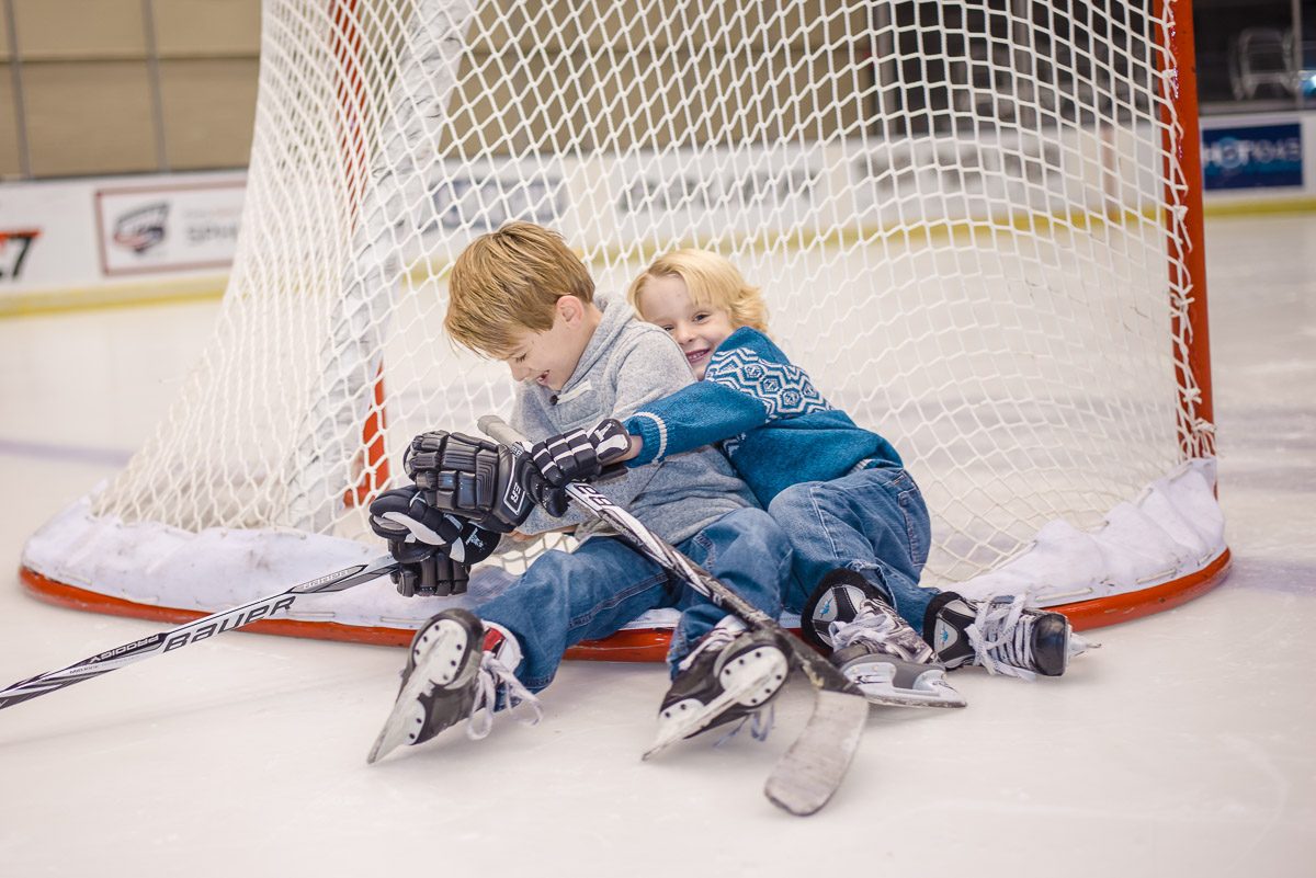 youth hockey players sitting on the back of a hockey net at Knoxville civic coliseum