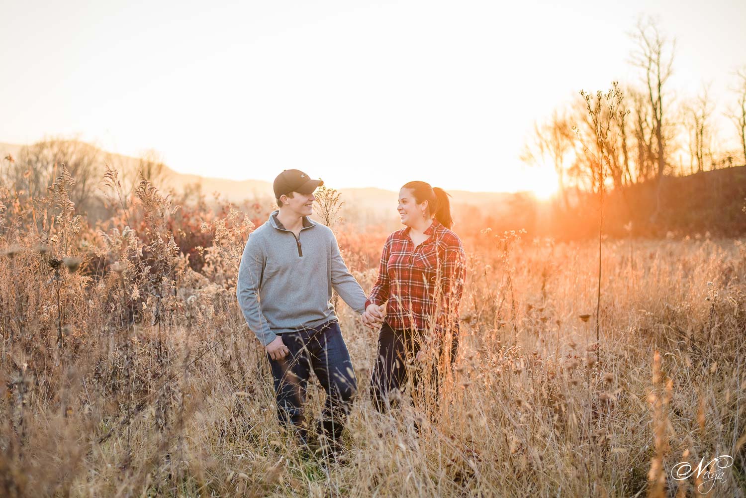engaged couple walking at sunset in Cade's Cove TN