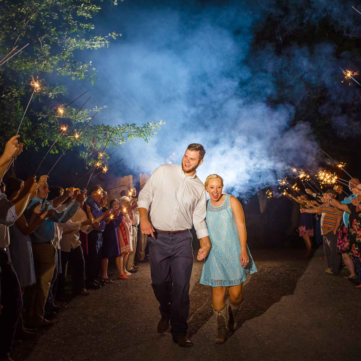 best sparkler wedding exit with bride in short blue lace dresse 