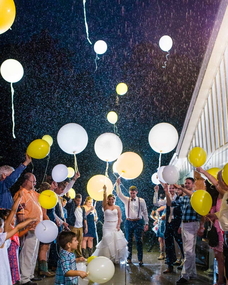 balloon wedding exit in the rain at night