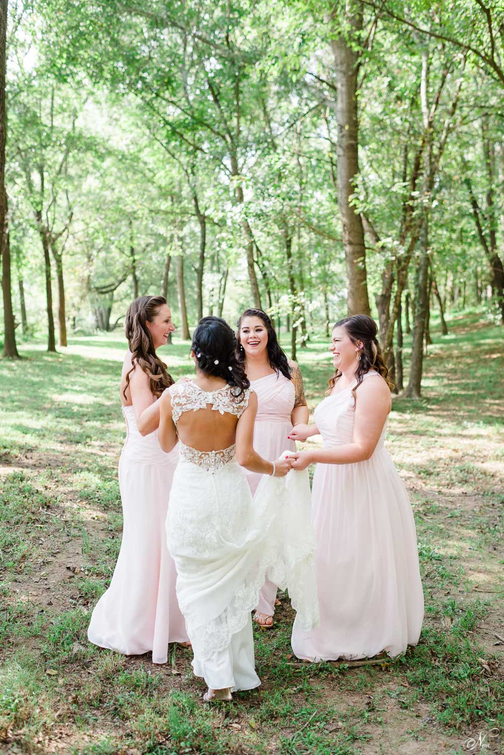 bride and bridesmaids dancing in the forest at Hiwassee River Weddings