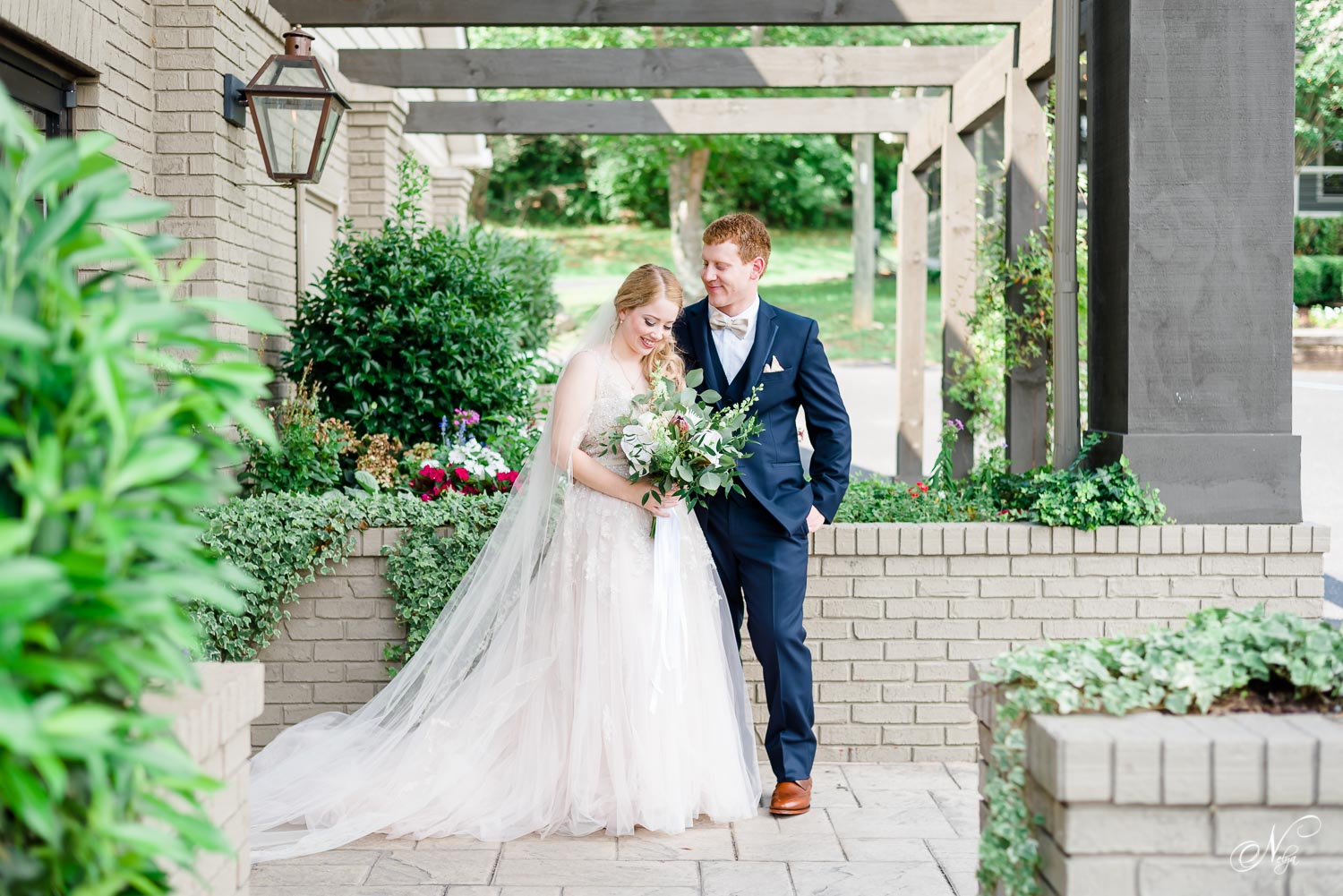 bride and groom outside under front trellis at The Venue Chattanooga in July
