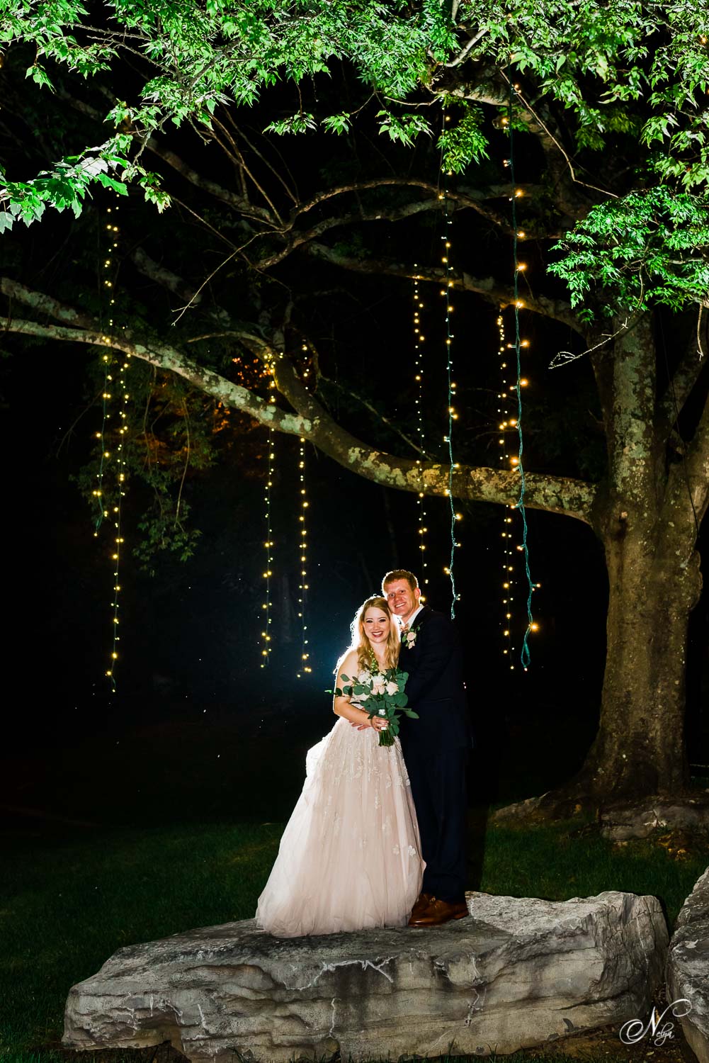 bride and groom outside at night under tree with twinkly lights at The Venue in Chattanooga TN