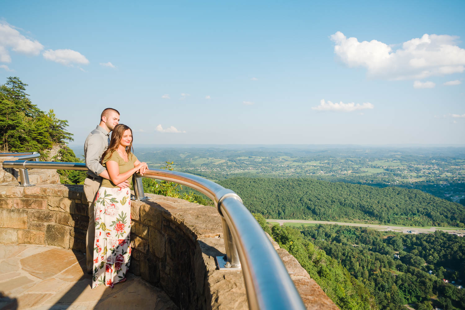 two people looking down on the Town of Cumberland Gap TN from the Pinnacle Overlook in KY
