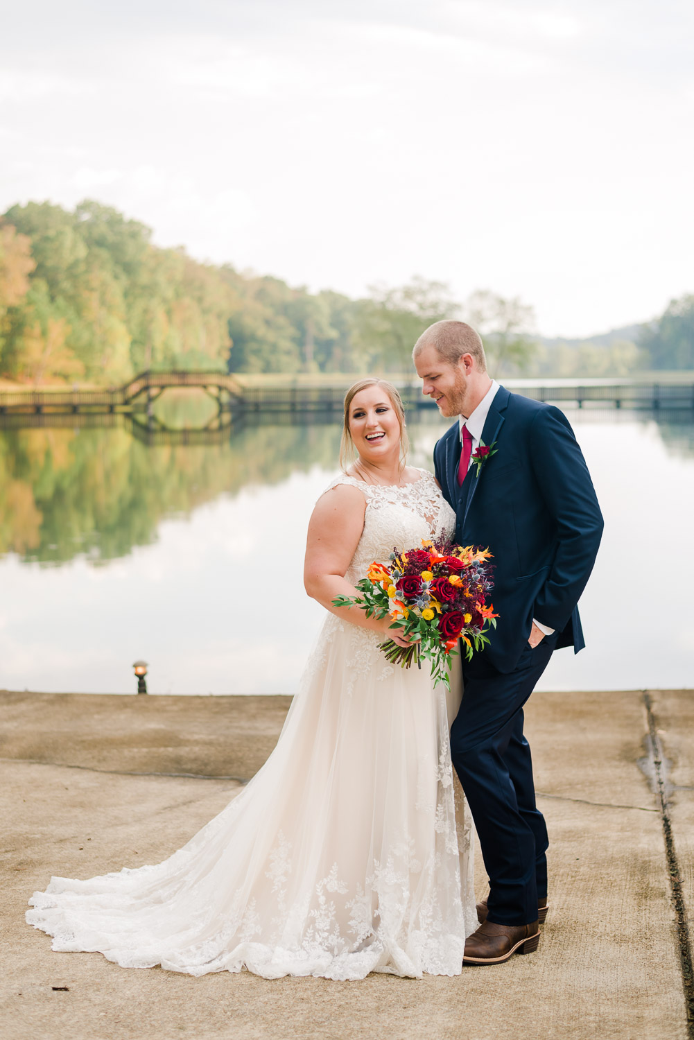 bride and groom outside by the pond at sunset in Dallas GA