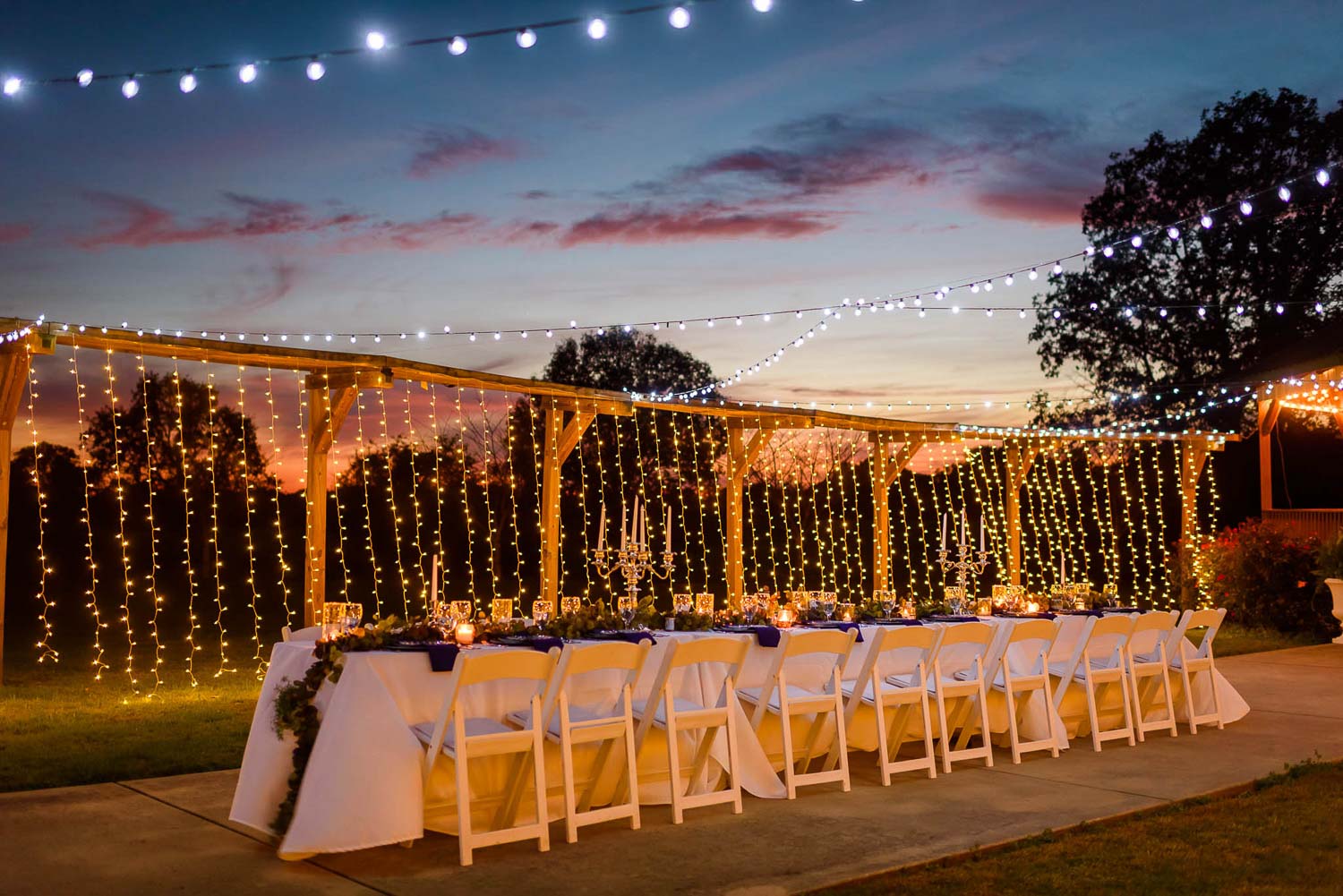 outdoor wedding reception with string lights at sunset in Trenton GA at Sunrise Farm