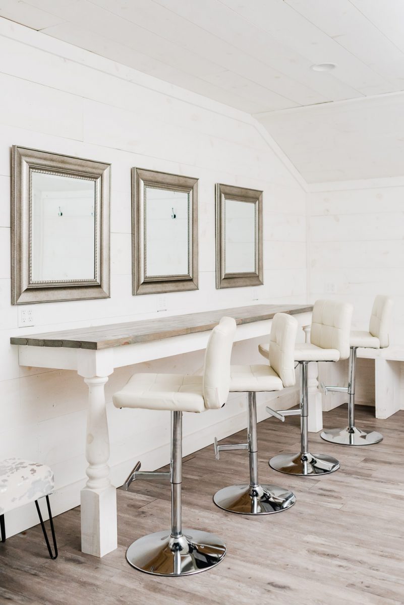 white swivel tall chairs in front of mirrors in the bridal suite at circle B Events