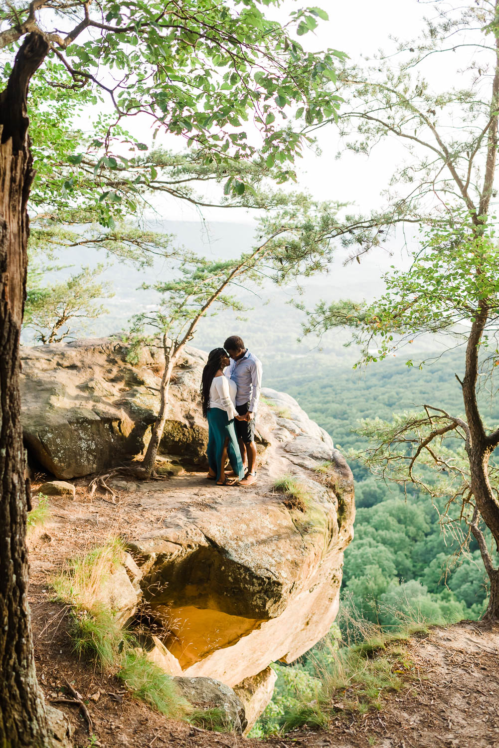 couple on clif at sunset rock in tennessee