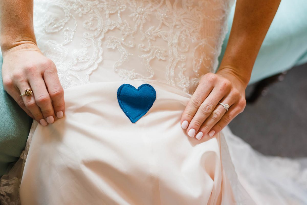 blue heart sewed onto a wedding dress